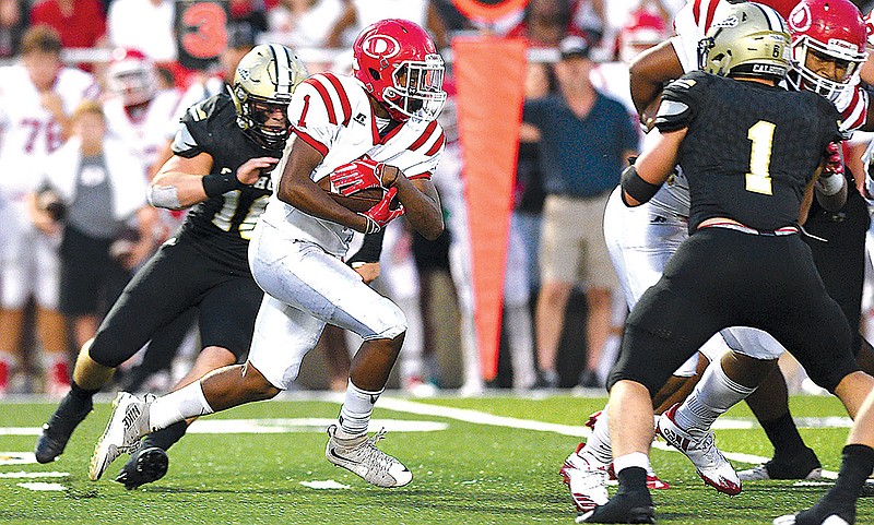 Dalton's Jahmyr Gibbs (1) finds a hole in the Calhoun defense. The Dalton Catamounts visited the Calhoun Yellow Jackets in GHSA high school football action on August 25, 2017. 