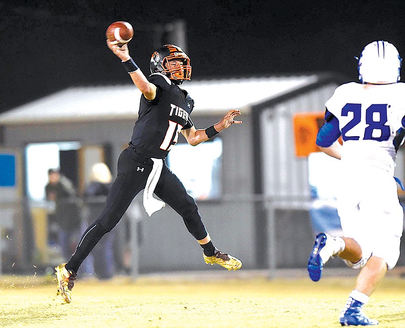 Meigs County quarterback Aaron Swafford (19) throws a pass on the run.  The Jackson County Blue Devils visited the Meigs County Tigers in the first round of the TSSAA playoff on November 4, 2016.