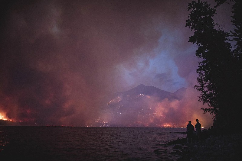 In this Aug. 12, 2018, photo provided by the National Park Service, the Howe Ridge Fire is seen from across Lake McDonald in Glacier National Park, Montana. (National Park Service via AP)