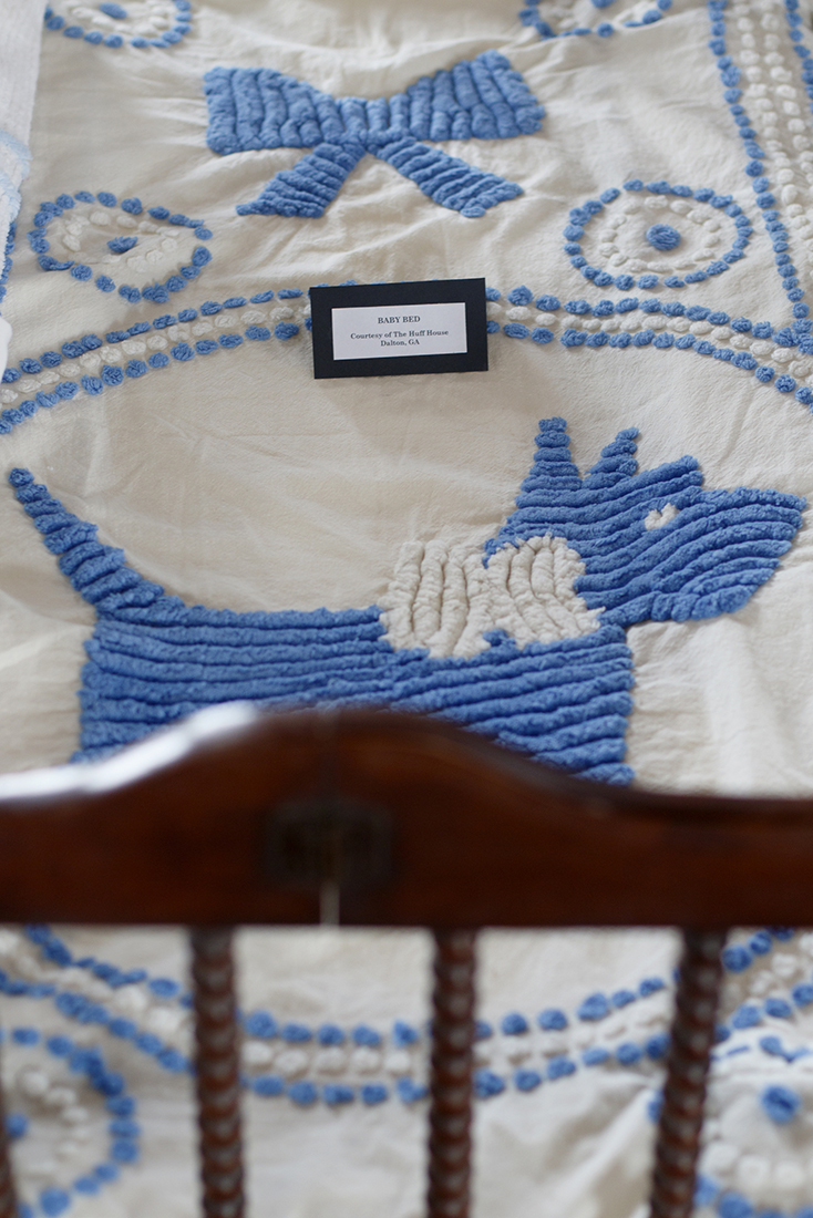 Staff photo by C.B. Schmelter /
A baby bed with a tufted design is seen in the Bandy Heritage Center for Northwest Georgia's Sandra Mahs exhibit at the Dalton Freight Depot on Wednesday, Aug. 15, 2018 in Dalton, Ga. The display represents one woman's search to find as many hand-tufted (and some machine-tufted) chenille bedspreads as she could find. Tufting was a cottage industry in the early 1900s that eventually led to Dalton's dominance in carpets and textiles. Sandra Mahs lives in Illinois, but some of her people were involved in the early days of tufting. Over about 20 years, she made it her mission to find as many spreads as she could to show the ingenuity and craftsmanship of Northwest Georgia residents. She recently donated most of her collection to the Bandy Center.