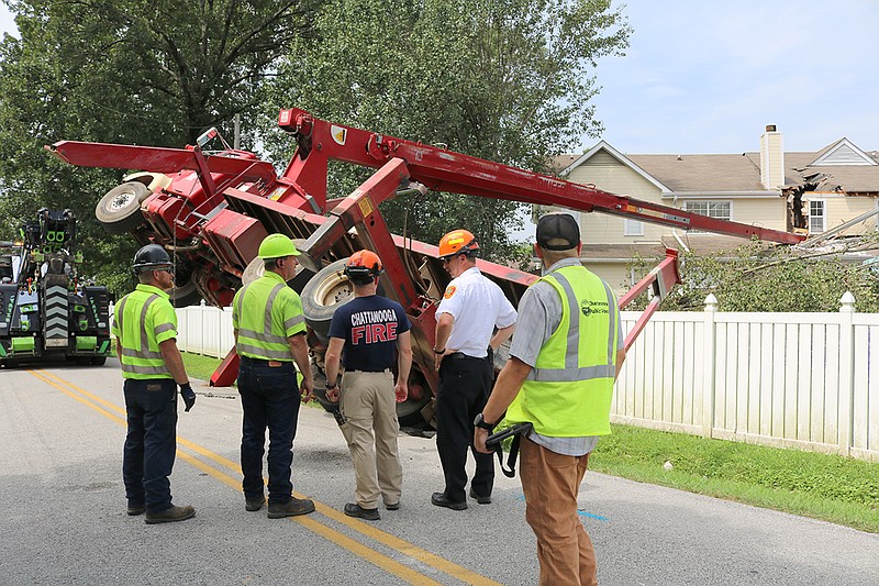 A toppled crane blocked part of East Boy Scout Road in its 1700 block Wednesday, Aug. 15, 2018, after a crane that was being operated by Big Woody's Tree Service fell over onto a condo in the Jackson Square subdivision about 2 p.m., the Chattanooga Fire Department reported on Twitter. (Photo: Bruce Garner/Chattanooga Fire Department)