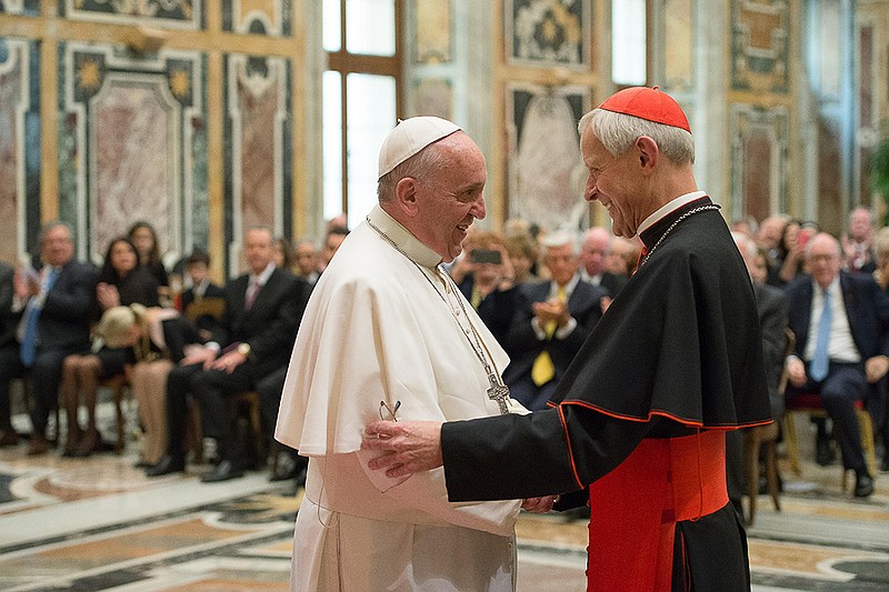 FILE - In this April 17, 2015, file photo, Pope Francis, left, talks with Papal Foundation Chairman Cardinal Donald Wuerl, Archbishop of Washington, D.C., during a meeting with members of the Papal Foundation at the Vatican.