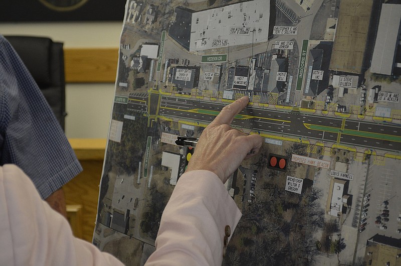 Fort Oglethorpe Councilwoman Paula Stinnett points to businesses along Lafayette Road during an open house session at city hall about the coming improvement project. The green lines on the map indicate the raised medians that some business owners are worried might deter potential customers from visiting. (Staff photo by Myron Madden)