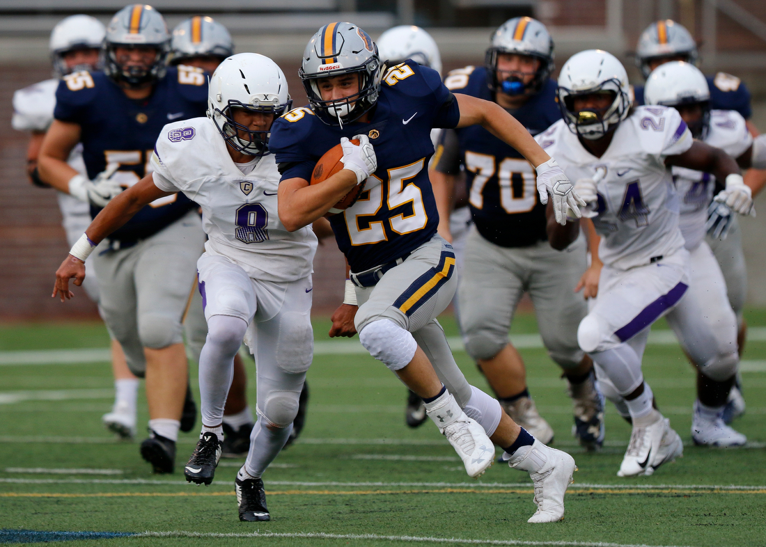 Staff photo by C.B. Schmelter /
Central's Jay Jones (8) closes in on Walker Valley's Heath Tanksley (25) during the first game of the Chattanooga Kickoff Classic at Finley Stadium on Thursday, Aug. 16, 2018 in Chattanooga, Tenn.