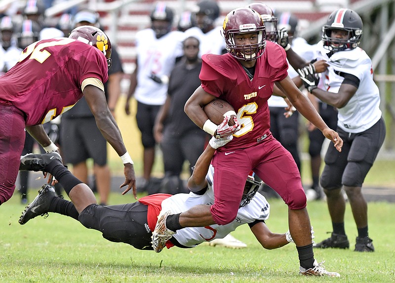 Howard's Javion Robinson breaks the tackle of Brainerd's Jamal Ward on his way to the end zone during Saturday's game at Howard. It was Robinson's second touchdown of the game, which started Friday but was suspended because of inclement weather. The host Hustlin' Tigers won 18-0. 