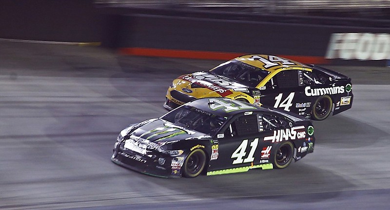 Kurt Busch drives past Clint Bowyer during Saturday night's NASCAR Cup Series race at Tennessee's Bristol Motor Speedway. Busch won to secure a spot in the playoffs with just two more races before they begin.