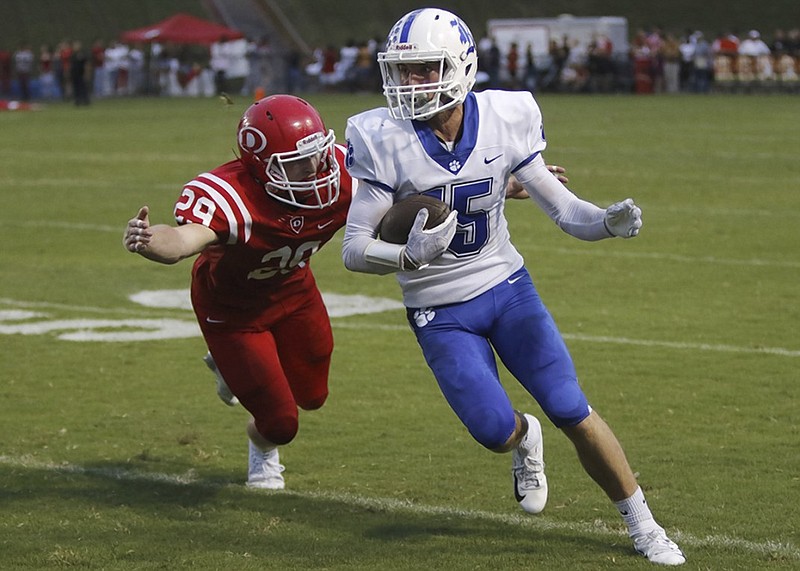 Dalton's Jack Ridley closes in on Ringgold's Dylan Wright during Friday night's game at Harmon Field in Dalton, Ga.