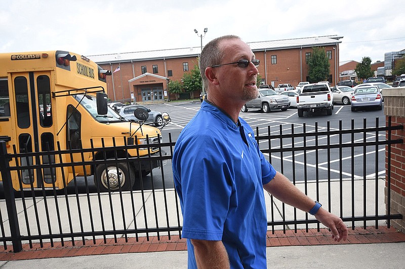 Trion High School Athletic Director Jason Lanham walks and talks about the possibility of a police presence on site at the school where a maintenance facility stands. "We would repurpose some of this building and use a new emergency entrance that has been cut in already," Lanham said.