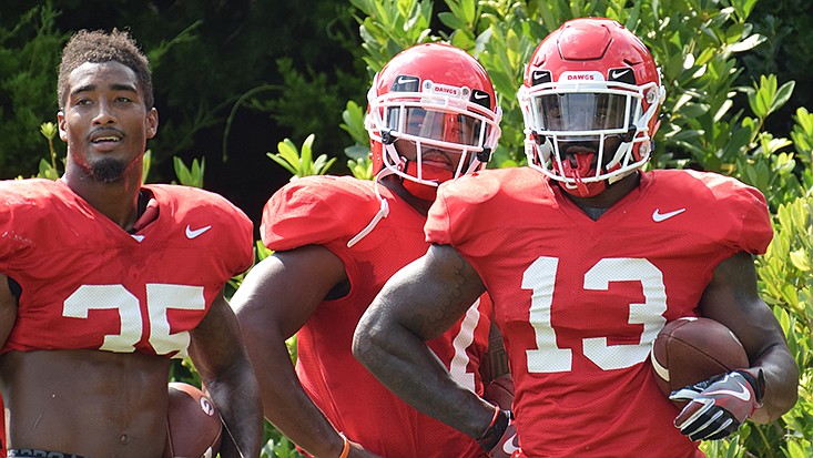 Georgia tailbacks Brian Herrien (35), D'Andre Swift (7) and Elijah Holyfield (13) during the Bulldogs' practice on the Woodruff Practice Fields in Athens, Ga., on Tuesday, Aug. 21, 2018. (Photo by Steven Colquitt)