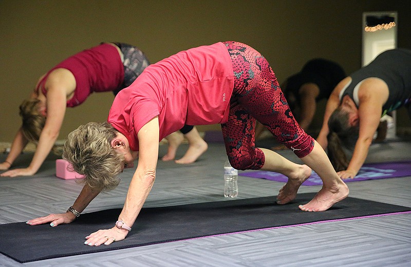 Debbie Pickett, 70, proudly says she is the oldest participant in a yoga class at White Oak Baptist Church. Instructors say yoga can help with many symptoms of aging, such as balance.