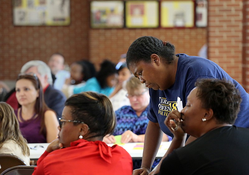 Staff photo by Erin O. Smith / 
Cassandra Robinson, who has children that graduated from Howard, works with others during a visioning event to come up with ideas for the new Howard Middle School Thursday, August 23, 2018 at Howard High School in Chattanooga, Tennessee. Attendees sat in groups, watched videos and came up with ideas for what they believed the new Howard Middle School should look like.