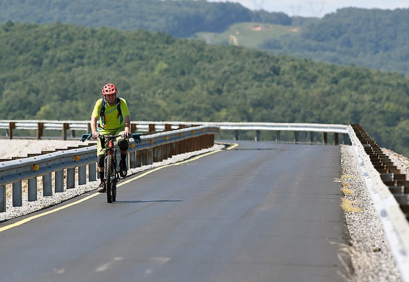 Mountain bike rider Mike Jones rides the one-lane road around Raccoon Mountain reservoir.