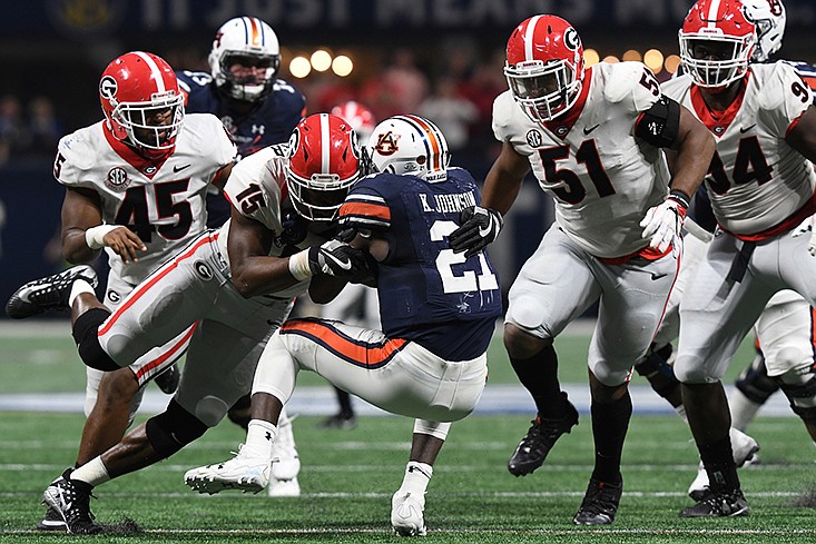 
Georgia outside linebacker D'Andre Walker (15) stops Auburn running back Kerryon Johnson during a game on Saturday, December 2, 2017 at SEC title game at Mercedes Benz Stadium in Atlanta. / Georgia photo by Perry McIntyre Jr.