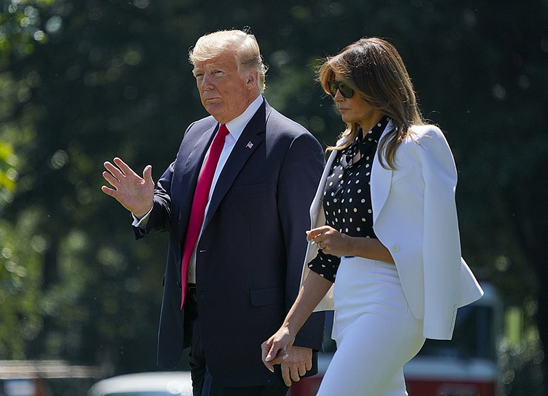 President Donald Trump and first lady Melania Trump walk across the South Lawn of the White House in Washington, Friday, Aug. 24, 2018, to board Marine One helicopter for a short trip to Andrews Air Force Base, Md., en route to Columbus, Ohio. (AP Photo/Pablo Martinez Monsivais)