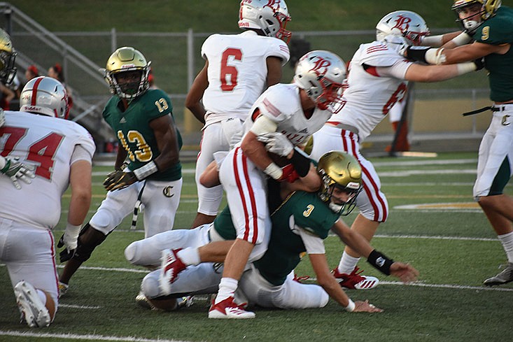 A Baylor School ball carrier is tacked by Knoxville Catholic defenders on Friday, Aug. 24 at Knoxville Catholic High School. Catholic won 35-16.
 / Staff photo by David Cobb