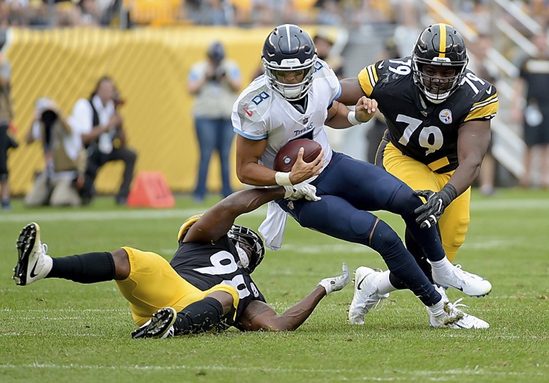 Tennessee Titans quarterback Marcus Mariota is sacked by Pittsburgh Steelers linebacker Vince Williams, left, and defensive tackle Javon Hargrave during Saturday's preseason matchup in Pittsburgh.