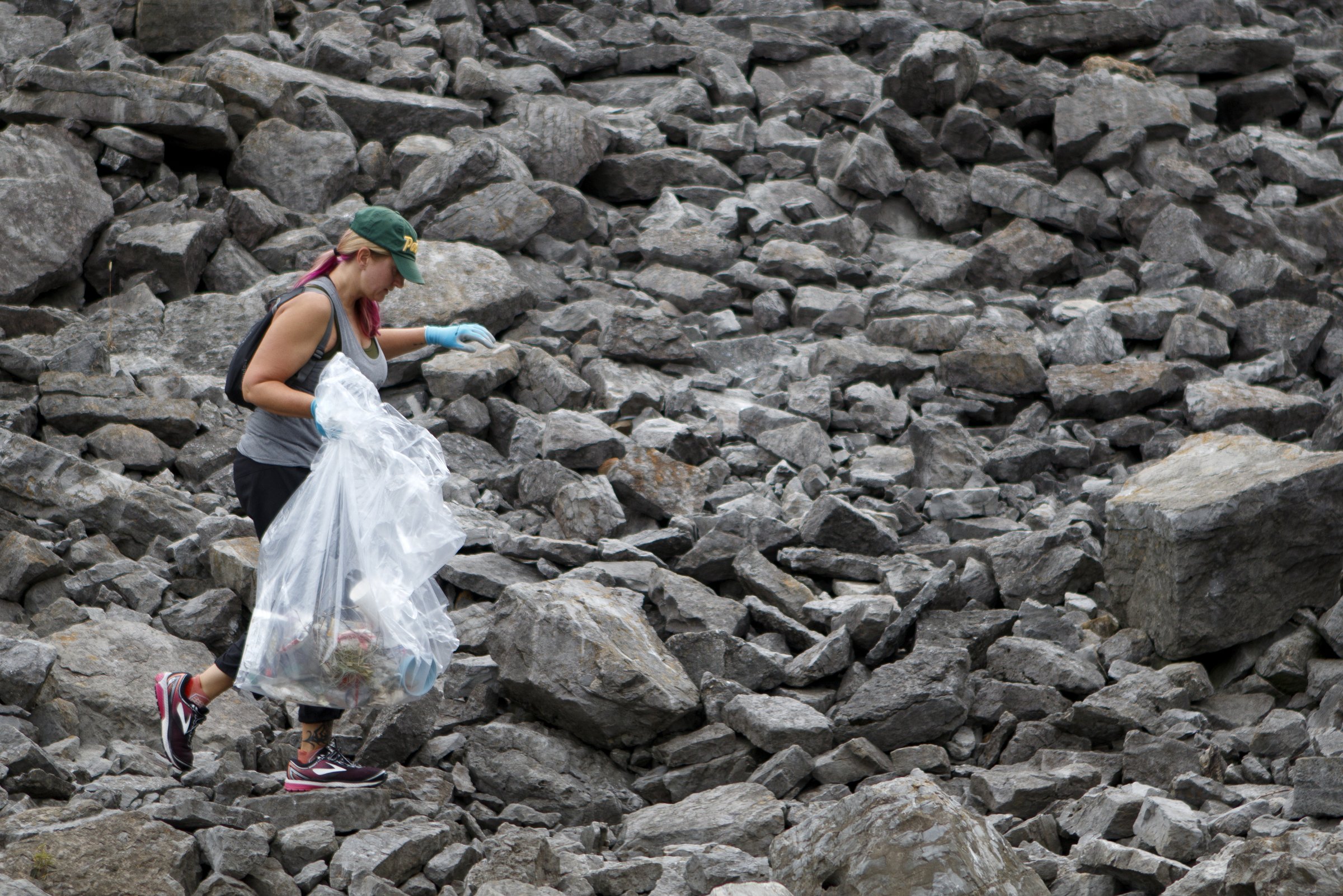 Kim Turner picks up trash along the Tennessee Riverwalk at the Chickamauga Dam during a cleanup organized by GreenSteps and The Wilderness Society.