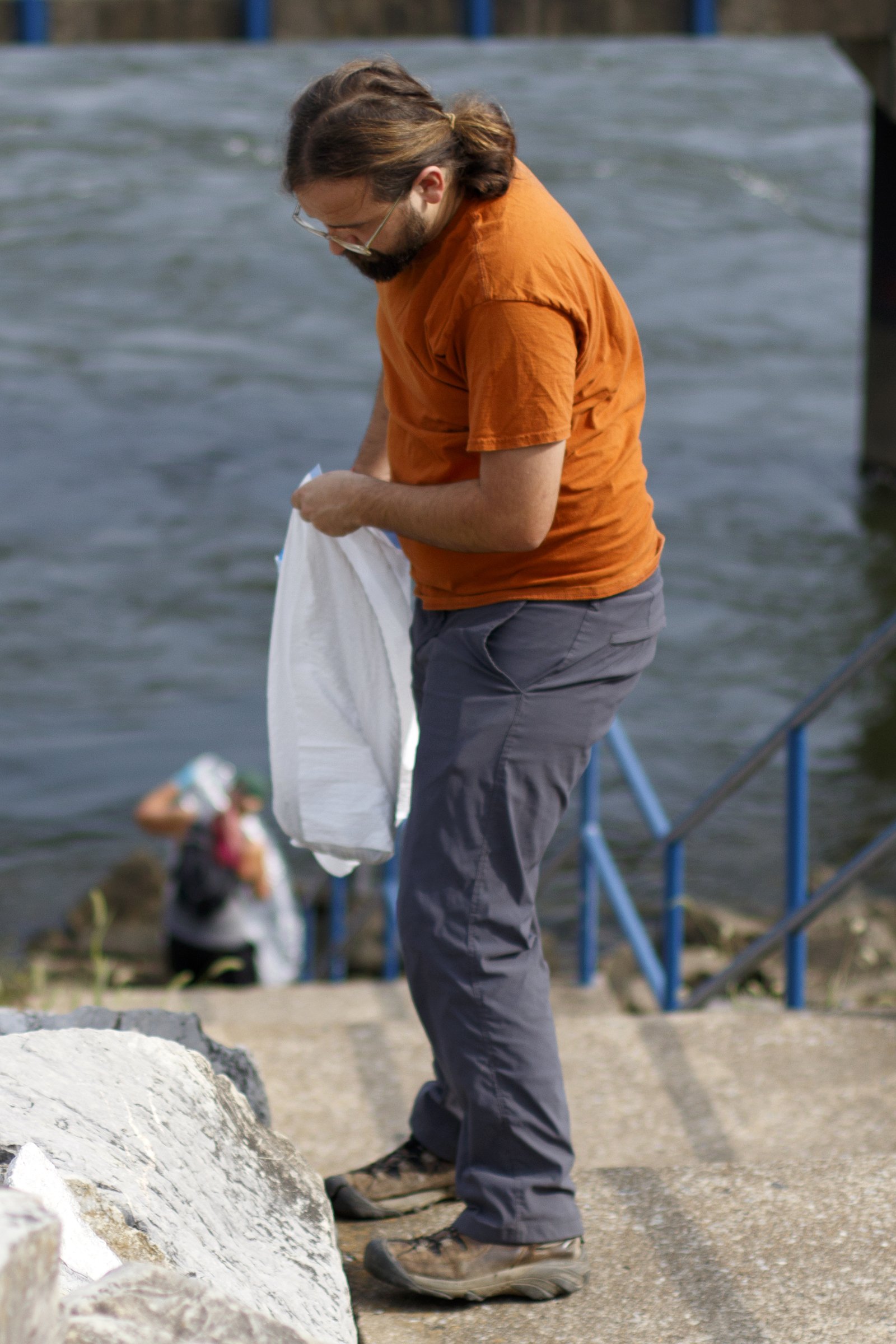 Robert Altonen, the watershed project coordinator for the Southeast Tennessee Resource Conservation and Development Council, picks up trash along the Tennessee Riverwalk at the Chickamauga Dam.
