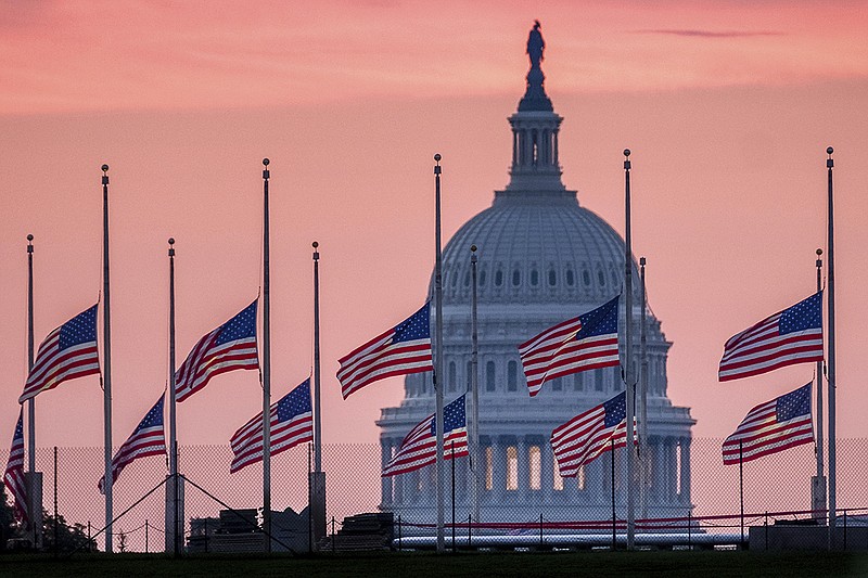 Flags fly at half-staff in honor of Sen. John McCain, R-Ariz., around the U.S. Capital at daybreak in Washington, D.C., on Sunday.