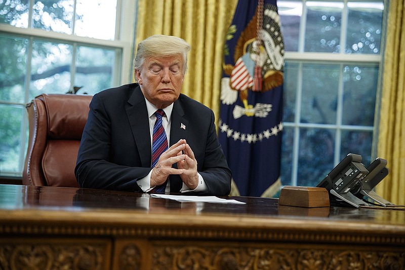 President Donald Trump listens during a phone call with Mexican President Enrique Pena Nieto about a trade agreement between the United States and Mexico, in the Oval Office of the White House on Monday. (AP Photo/Evan Vucci)