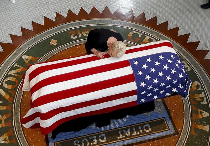 Cindy McCain, wife of, Sen. John McCain, R-Ariz. lays her head on his casket during a memorial service at the Arizona Capitol on Wednesday, Aug. 29, 2018, in Phoenix. (AP Photo/Ross D. Franklin, Pool)

