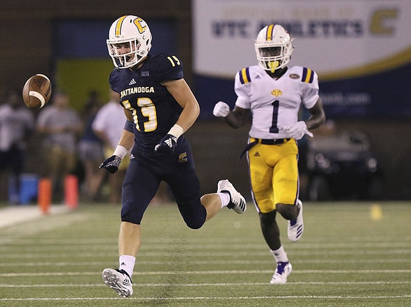 The ball is overthrown as UTC wide receiver Bryce Nunnelly attempts to catch up to it with Tennessee Tech defensive back Dami Adekunjo trailing during Thursday night's season opener at Finley Stadium.