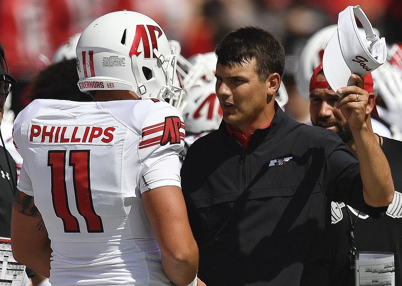 Austin Peay head coach Will Healy speaks to kicker Cole Phillips during Saturday's game against Georgia in Athens.