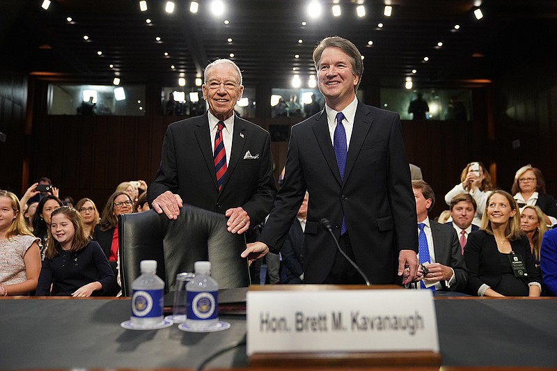 Supreme Court nominee Brett Kavanaugh, standing with Senate Judiciary Chairman Chuck Grassley, R-Iowa, arrives at the Senate Judiciary Committee on Capitol Hill, Tuesday, Sept. 4, 2018, in Washington, to begin his confirmation hearing to replace retired Justice Anthony Kennedy. (AP Photo/Andrew Harnik)