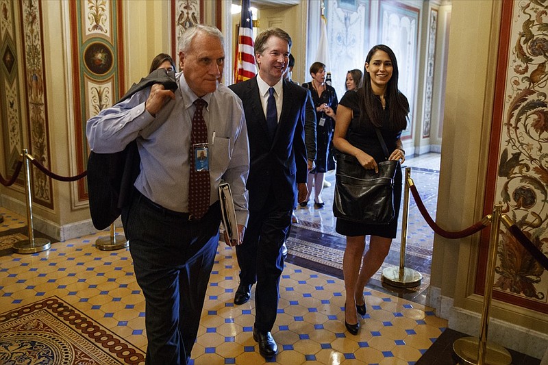 FILE - In this July 11, 2018, file photo, Supreme Court nominee Brett Kavanaugh is escorted by former Sen. Jon Kyl, R-Ariz., to a meeting on Capitol Hill in Washington. Sen. John McCain's widow on Tuesday, Sept. 4, 2018, said Kyl will fill her late husband's seat. (AP Photo/Evan Vucci, File)

