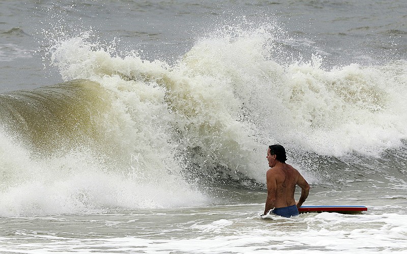 Chris Stebly tries to catch some waves as Tropical Storm Gordon heads towards the coast on Tuesday, Sept. 4, 2018, in Dauphin Island, Ala. (AP Photo/Dan Anderson)