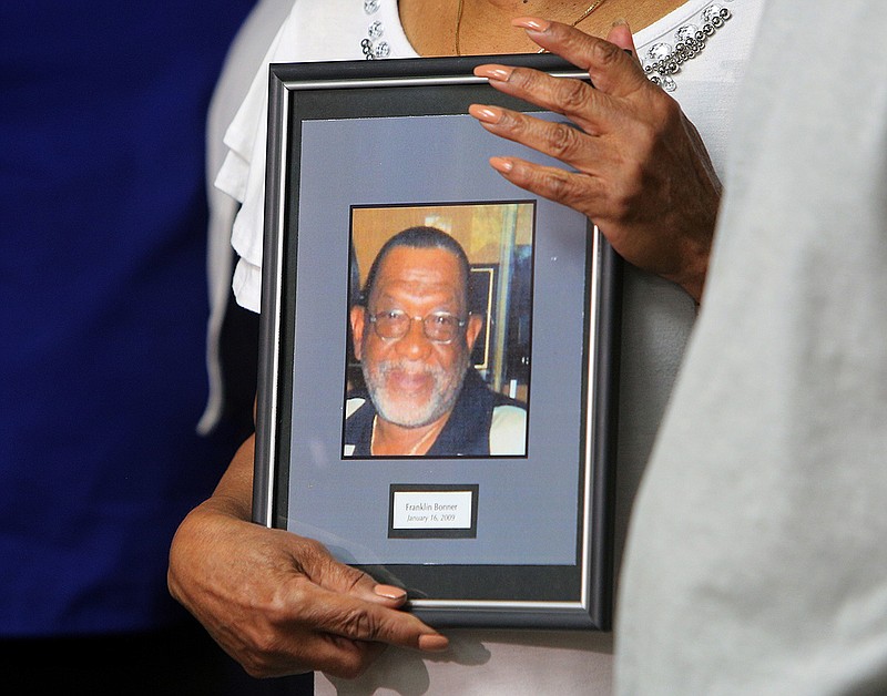 Linda Bonner holds onto a photo of her late husband, Franklin Bonner, during a news conference at Newell Towers on June 12, 2018, in Chattanooga, Tennessee.