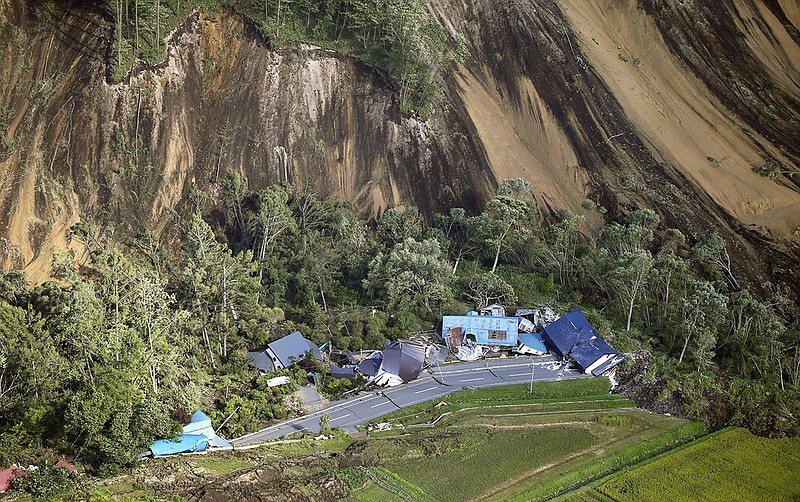 This aerial photo shows houses destroyed by a landslide after an earthquake in Atsuma town, Hokkaido, northern Japan, Thursday, Sept. 6, 2018. A powerful earthquake rocked Japan's northernmost main island of Hokkaido early Thursday, triggering landslides that crushed homes, knocking out power across the island, and forcing a nuclear power plant to switch to a backup generator. (Kyodo News via AP)