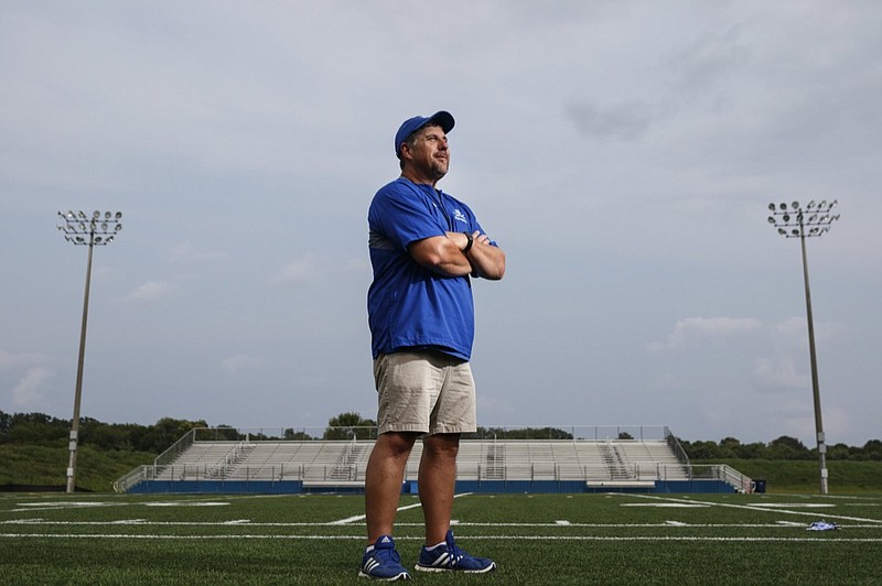 Staff photo by Doug Strickland / 
Boyd-Buchanan football coach Kevin Rodriguez poses for a portrait on the Boyd-Buchanan football field on Wednesday, Aug. 22, 2018, in Chattanooga, Tenn. Rodriguez met his biological father for the first time at age 50, thanks to his wife Barbara's work tracking him down.