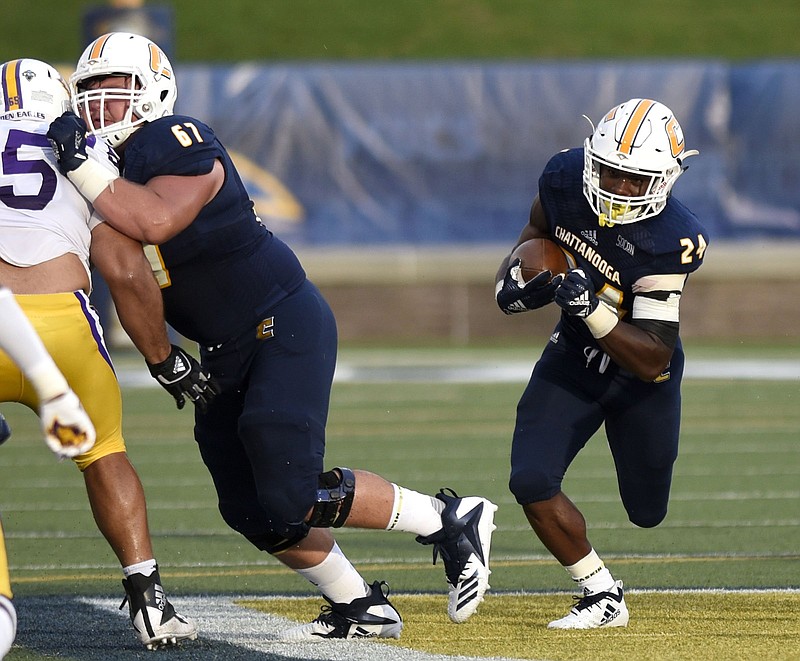 Alex Trotter carries the football behind the block of Noah Ramsey during UTC's season-opening win against Tennessee Tech last week at Finley Stadium. The Mocs made improving their offensive line and running game an offseason priority enter Tom Arth's second year as head coach.