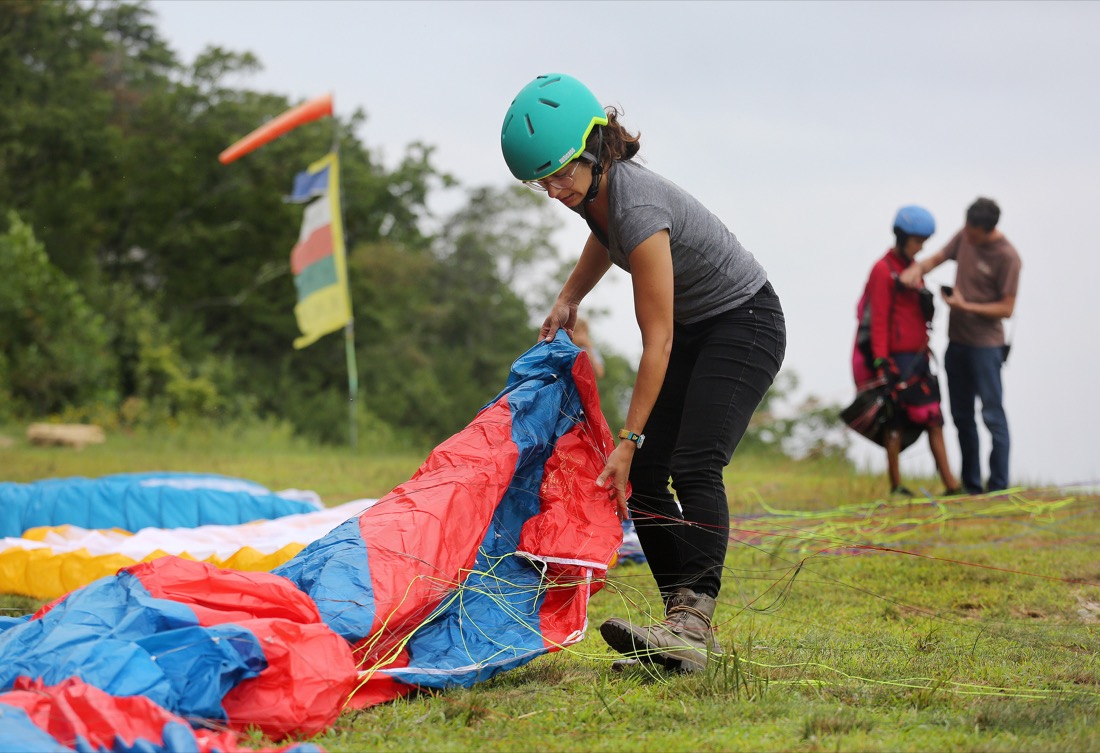 Hailey Hebert of Lafayette, Louisiana, gets her paraglider prepared before the Hurricane Open 2018 paragliding event Wednesday, September 5, 2018 in Whitwell, Tennessee. Hebert started paragliding in April 2018 and did her training in Whitwell.