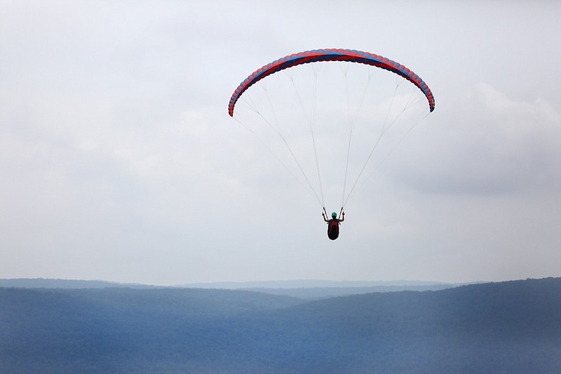 Hailey Hebert of Lafayette, Louisiana, glides of the side of the mountain before the Hurricane Open 2018 paragliding event Wednesday, September 5, 2018 in Whitwell, Tennessee. Hebert started paragliding in April 2018 and did her training in Whitwell. 