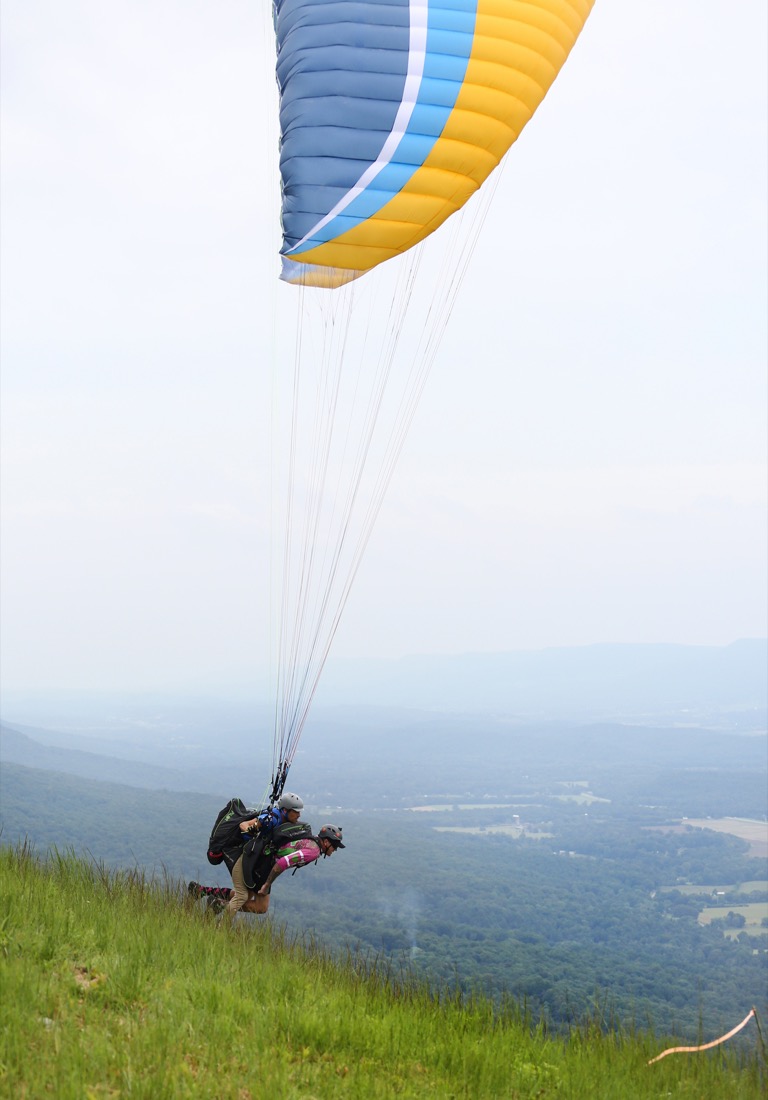 Shane Parreco of Asheville, North Carolina, and Christopher Pyse of Seattle, Washington, tandem paraglide before the Hurricane Open 2018 paragliding event Wednesday, September 5, 2018 in Whitwell, Tennessee. Parreco was working on getting his tandem instructor rating, while Pyse was the tandem instructor.