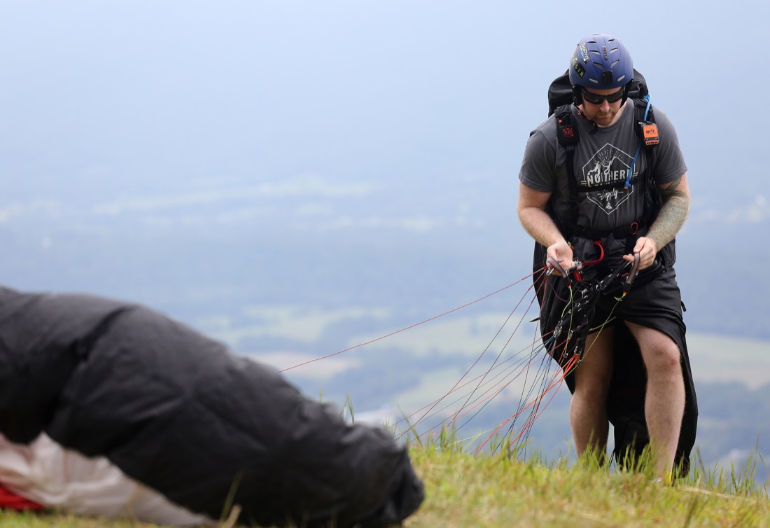 Leighton Joll of New Zealand gets his parachute ready before the Hurricane Open 2018 paragliding event Wednesday, September 5, 2018 in Whitwell, Tennessee. Joll was attending a friend's wedding in Nashville over the weekend and decided he needed to pack his paragliding gear and make trip out of it.