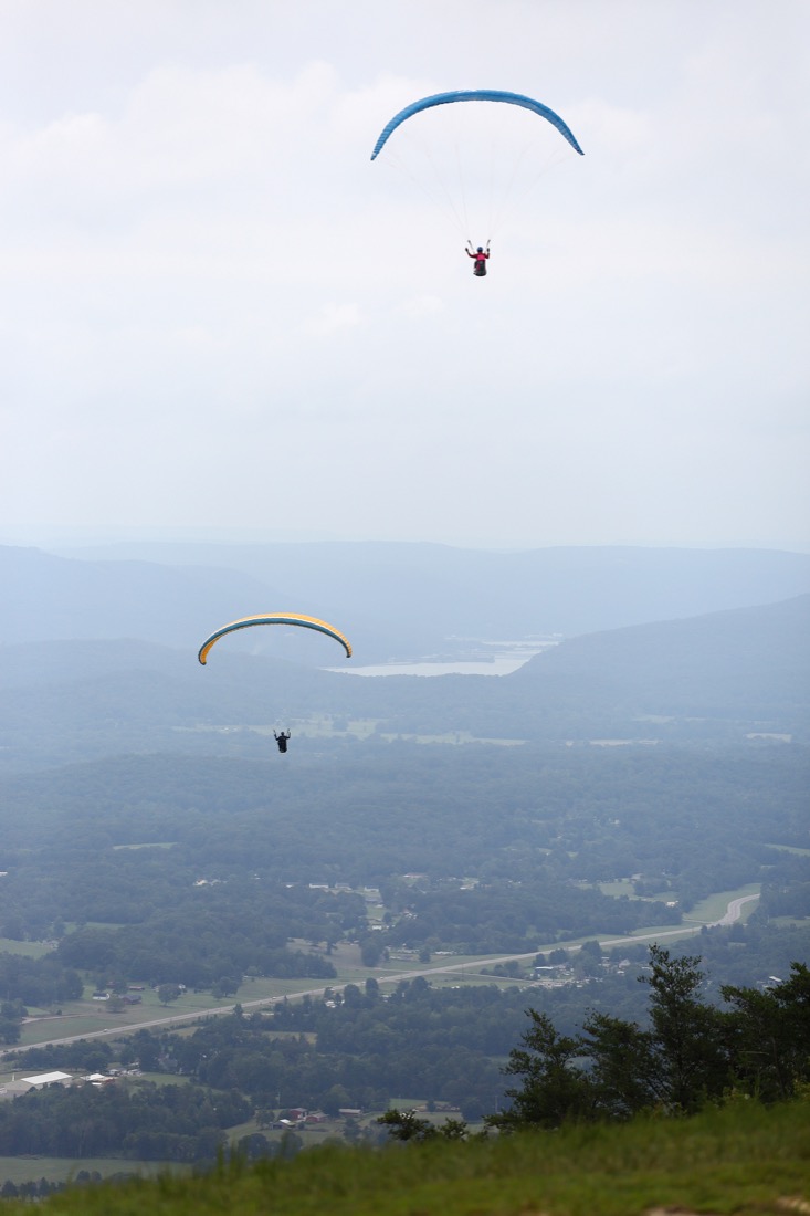 Pilots maneuver their way through the sky before the Hurricane Open 2018 paragliding event Wednesday, September 5, 2018 in Whitwell, Tennessee. There were 15 pilots participating in the competition Wednesday.