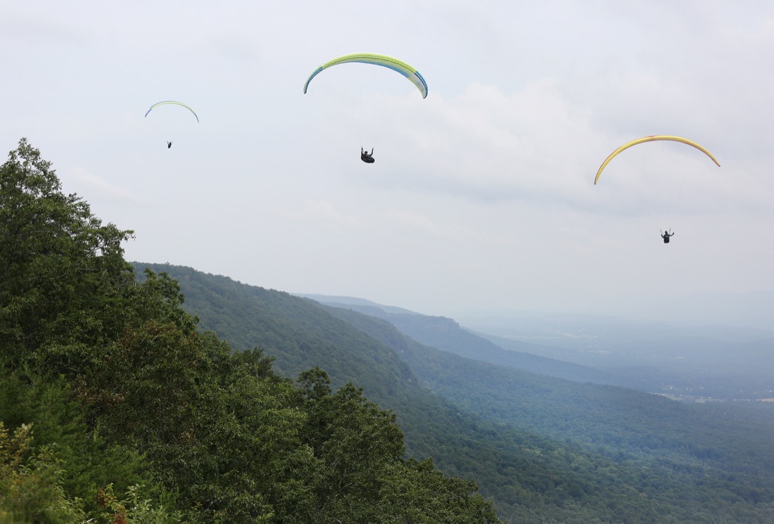 Pilots maneuver their way through the sky before the Hurricane Open 2018 paragliding event Wednesday, September 5, 2018 in Whitwell, Tennessee. There were 15 pilots participating in the competition Wednesday.
