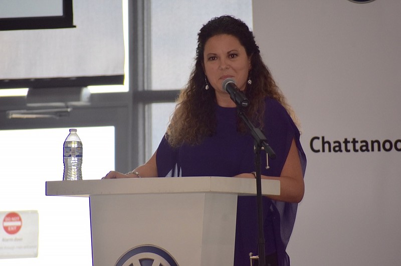 

Sabrina L. Butcher, the chief executive officer and founder of Chattanooga-based LUCYdoes who chairs the task force on All Lanes Open, addresses the crowd at the "Minding the Gaps" women's workforce symposium at the Volkswagen Conference Center on Thursday. / Staff photo by Allison Shirk