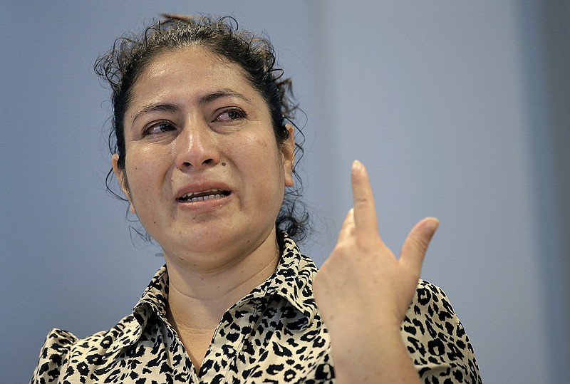 A mother from Guatemala, identified only by initials L.J., who was separated from her two children after entering the U.S. in May of 2018, is tearful while speaking to reporters about the separation during a news conference, Thursday, Sept. 6, 2018, in Boston. L.J. is among plaintiffs in a lawsuit against President Donald Trump's administration, seeking monetary damages on behalf of children who were separated from their parents at the border. (AP Photo/Steven Senne)