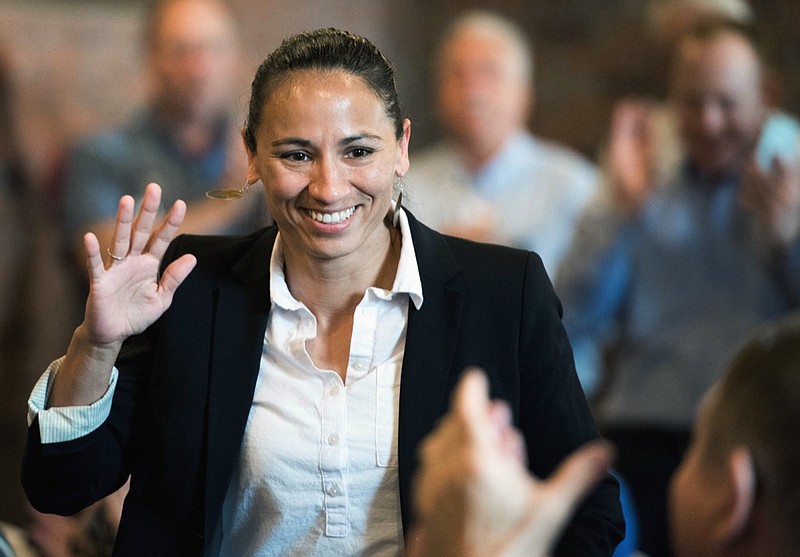 FILE - In this Aug. 8, 2018, file photo, Democrat Sharice Davids waves at her supporters at a Democratic event in Kansas City, Kan. An ad by Davids in Kansas 3rd Congressional District claiming she doesn't support abolishing ICE contradicts an earlier statement. Davids faces Republican Rep. Kevin Yoder in a district seen as a prime target for Democrats to flip. (Shelly Yang/The Kansas City Star via AP, File)

