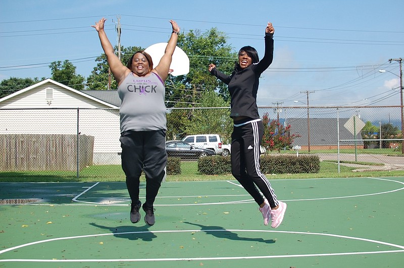 Lupus patients Tina Reid and Kenyetta Bray jump together in South Chattanooga. They are among several women organizing the Lapse for Lupus walk Sept. 22. (Contributed Photo by Bob James IV)