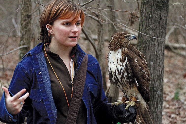 Vivian Anderson stands with her red-tailed hawk, Onhekwensa, which she trained to hunt in 2014. (Photo by Dan Henry)