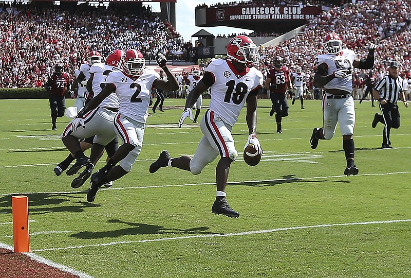 Georgia defensive back Deandre Baker returns an interception for a touchdown during the first quarter of Saturday's game at South Carolina.