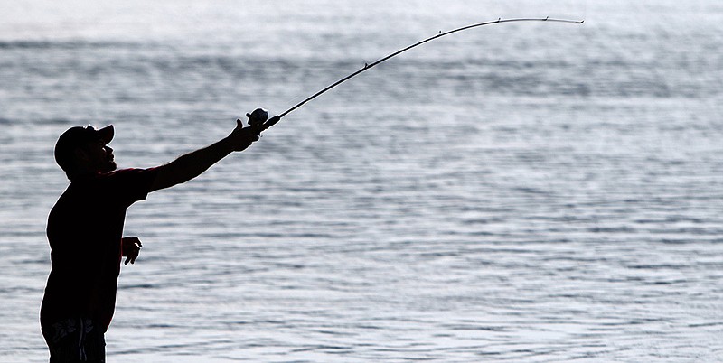 Johnathan Bice casts his line while fishing next to the boat ramp near the Hubert Fry Center along the Tennessee Riverpark on Friday, May 25, 2018 in Chattanooga, Tenn.