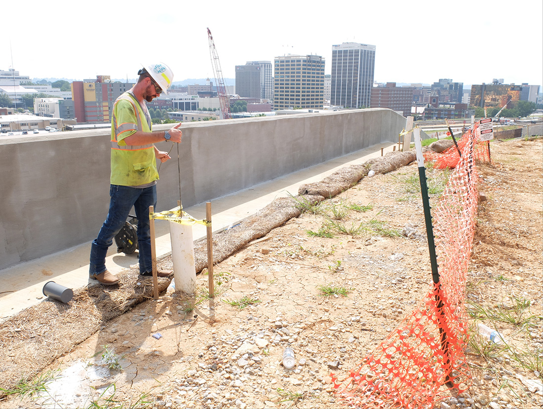Grady Stageberg, construction engineer inspector for Volkert Inc., lowers inclinometer equipment for a reading inside a 68-foot vertical core shaft high above the U.S. Highway 27 retaining wall in view of the 4th Street interchange. The Sept. 6, 2018 reading was a weekly test at this point in the project, according to Stageberg.