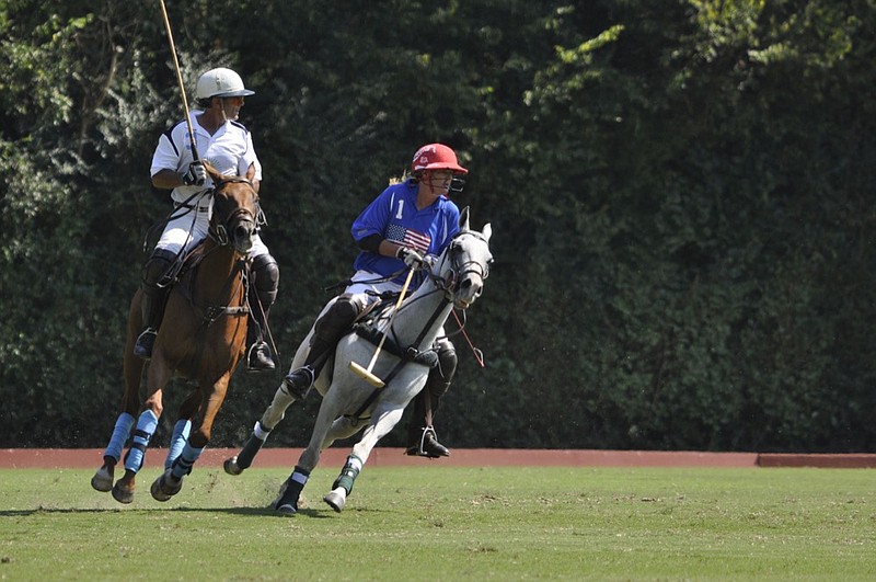 
Gillian Johnston, in red helmet, the highest-rated female player/sponsor in USA high goal polo, chases the polo ball at the 2017 match at Bendabout Farm. / Kym Thomas Photo
