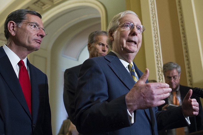 Senate Majority Leader Mitch McConnell of Ky., right, Sen. John Barrasso, R-Wyo., left, Sen. John Thune, R-S.D., center left, speak with reporters after the Republican policy luncheon on Capitol Hill, in Washington, Wednesday, Sept. 5, 2018. (AP Photo/Cliff Owen)

